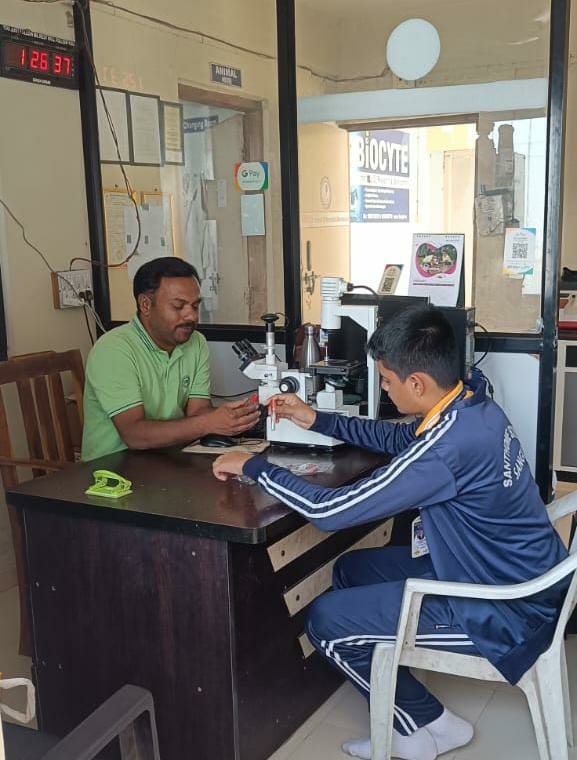 Empowering through hands-on learning: Beneficiary receiving guidance in laboratory techniques.